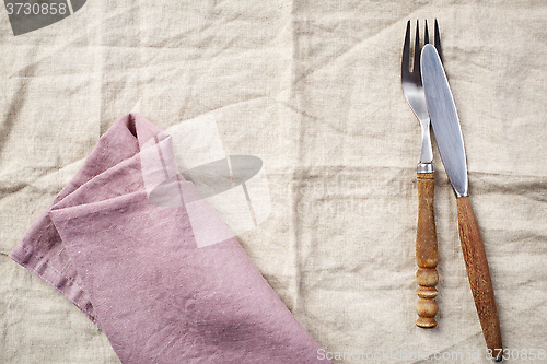 Image of linen napkin background with fork and knife