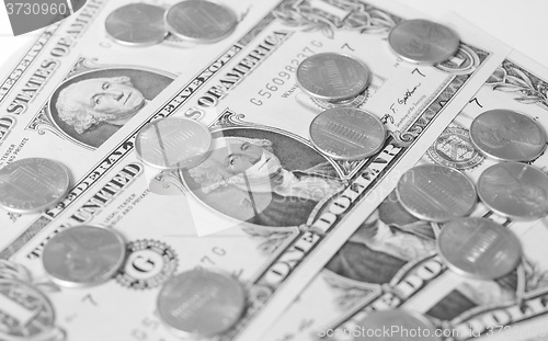 Image of Black and white Dollar coins and notes