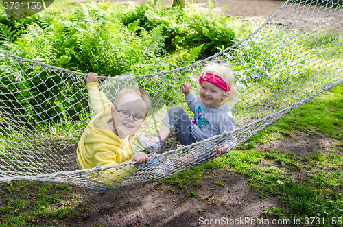 Image of Children swinging in a hammock