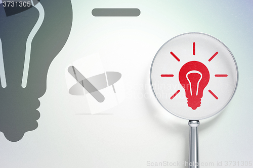 Image of Business concept:  Light Bulb with optical glass on digital background