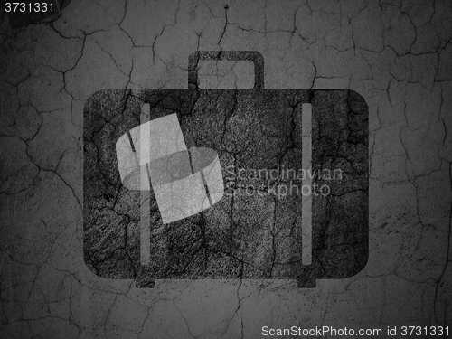 Image of Tourism concept: Bag on grunge wall background
