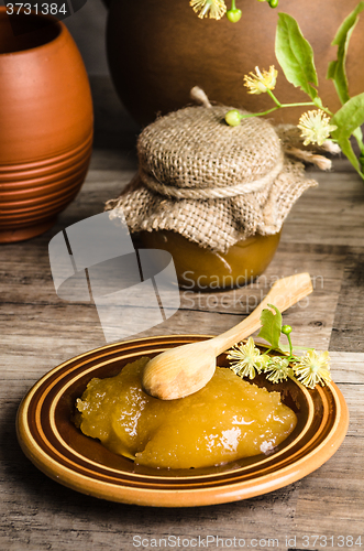 Image of Saucer with lime honey on the table,\rclose-up