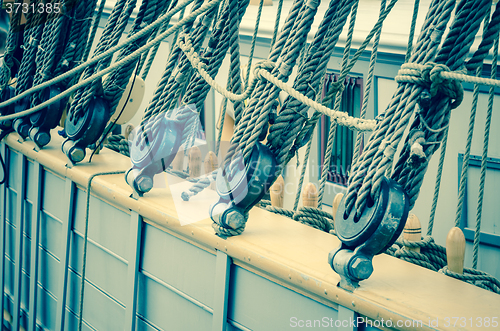 Image of Blocks and rigging of an old sailboat, close-up, toning