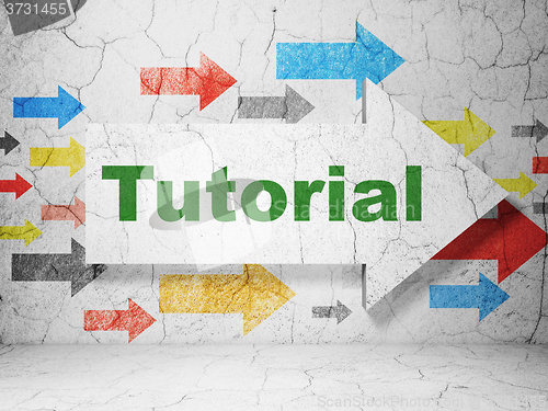 Image of Learning concept: arrow with Tutorial on grunge wall background