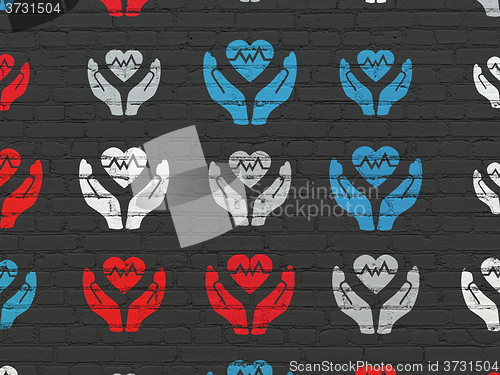 Image of Insurance concept: Heart And Palm icons on wall background