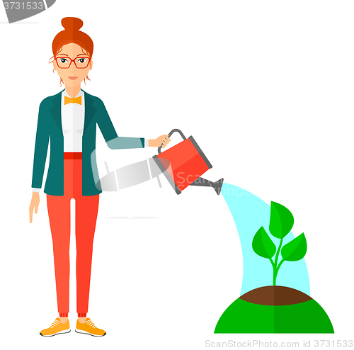 Image of Woman watering tree.