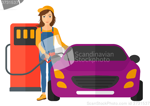 Image of Woman filling up fuel into car.