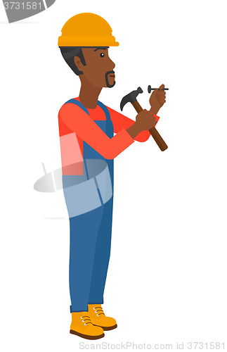 Image of Man hammering nail.