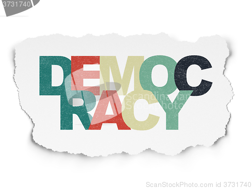 Image of Politics concept: Democracy on Torn Paper background