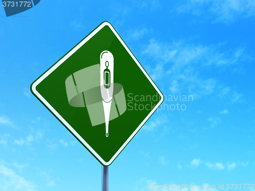 Image of Medicine concept: Thermometer on road sign background
