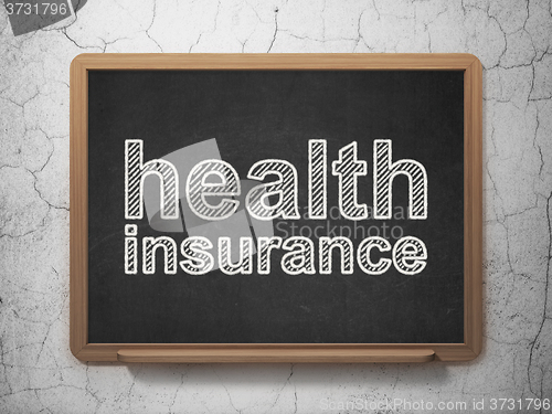 Image of Insurance concept: Health Insurance on chalkboard background
