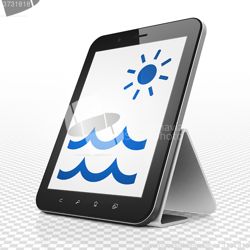 Image of Travel concept: Tablet Computer with Beach on display