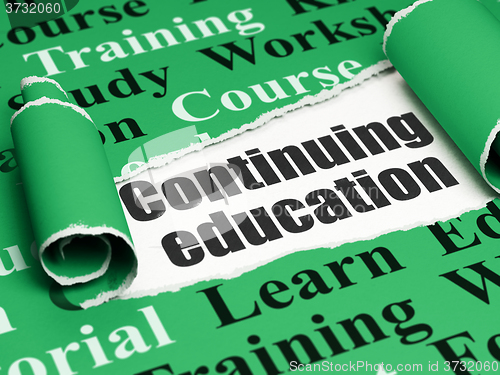 Image of Studying concept: black text Continuing Education under the piece of  torn paper