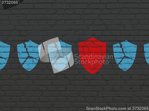 Image of Protection concept: shield icon on wall background