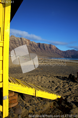 Image of lifeguard chair cabin lanzarote  rock stone sky   coastline and 