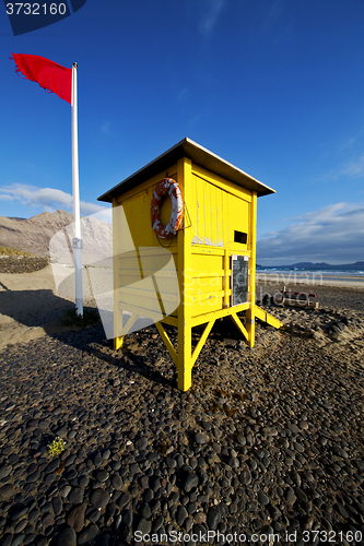 Image of lifeguard chair red flag in s  coastline and summer 