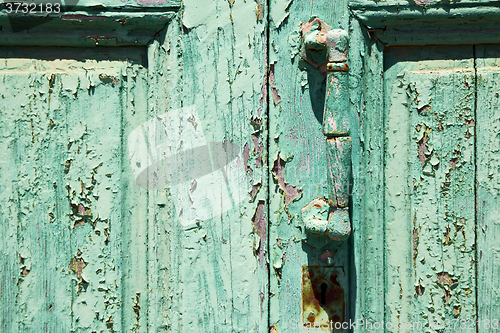 Image of spain canarias brass r in a green closed wood  door abstract 