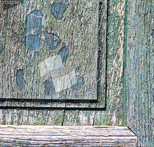 Image of  piece of wood brown knocker and wood  door cairate varese  