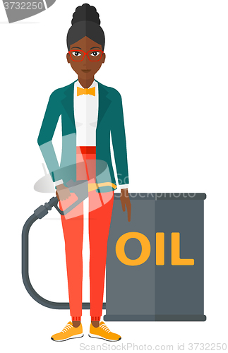 Image of Woman with oil can and filling nozzle.