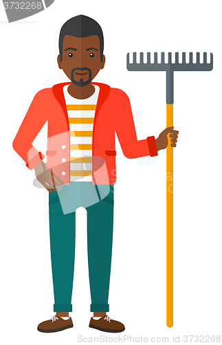 Image of Man standing with rake.
