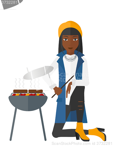 Image of Woman preparing barbecue.