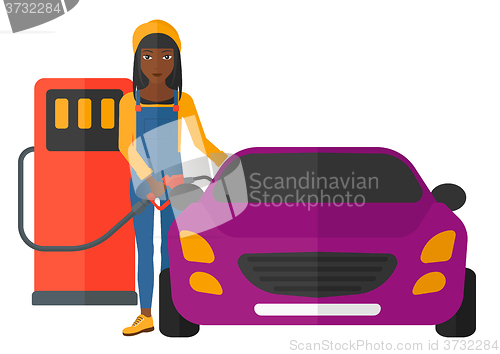 Image of Woman filling up fuel into car.