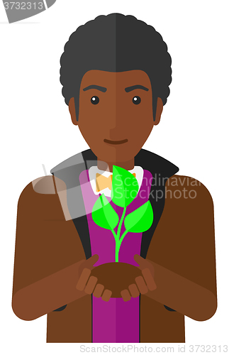 Image of Man holding plant.