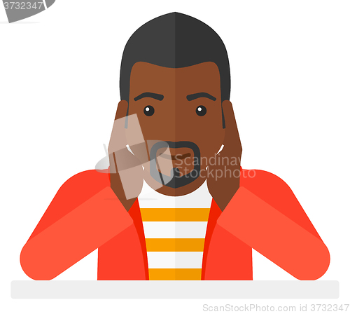 Image of Man in despair clutching his head.