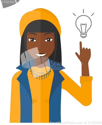 Image of Woman pointing at light bulb.