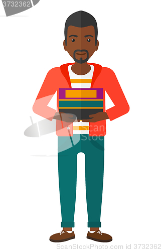 Image of Man holding pile of books.