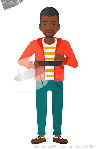 Image of Man using tablet computer.