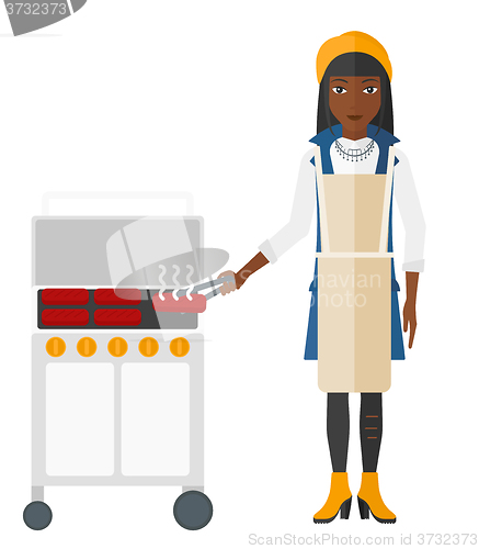 Image of Woman preparing barbecue.