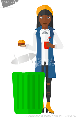 Image of Woman throwing junk food.