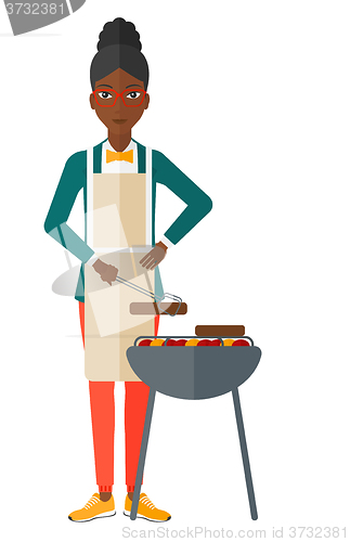 Image of Woman preparing barbecue.