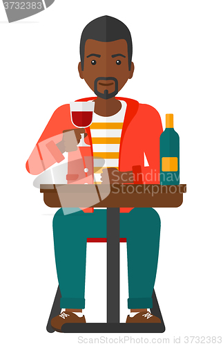 Image of Man sitting at bar.