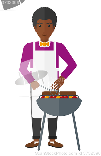 Image of Man preparing barbecue.