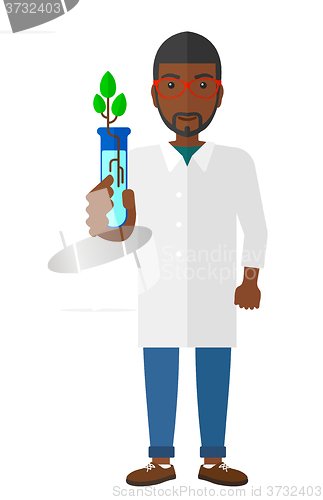 Image of Laboratory assistant with test tube.