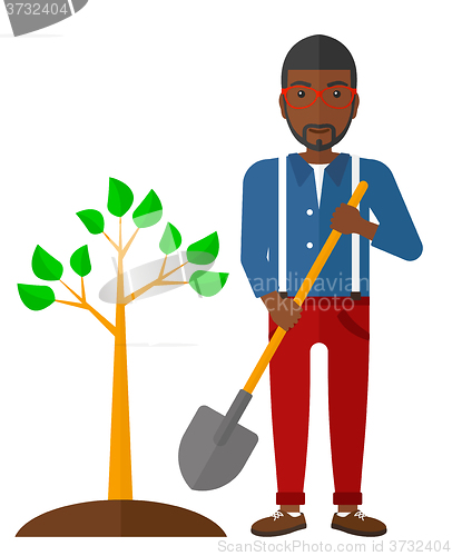 Image of Man plants tree.