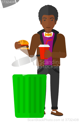 Image of Man throwing junk food.