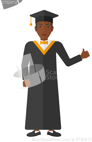 Image of Graduate showing thumb up sign.