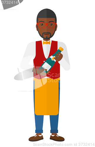 Image of Waiter holding bottle of wine.