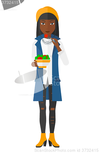 Image of Woman eating salad.