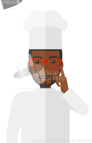 Image of Chef pointing forefinger up.