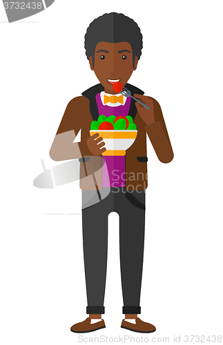Image of Man eating salad.