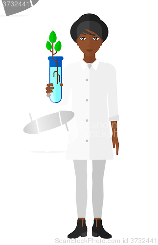 Image of Laboratory assistant with test tube.