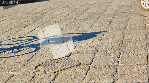 Image of shadow of cyclist during sunset, 