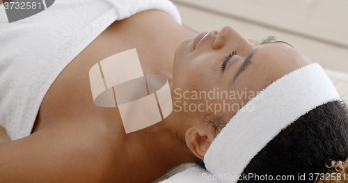 Image of Woman Relaxing On A Lounger With Eyes Closed