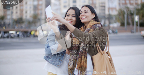 Image of Two gorgeous women posing for a selfie