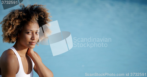 Image of Woman Taking Sunbath Near Swimming Pool