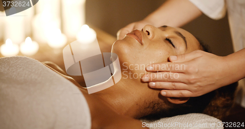 Image of Young Woman Enjoying Facial At Spa Salon